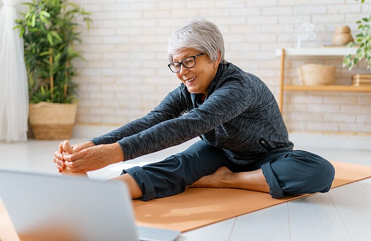 Senior woman exercising at home.