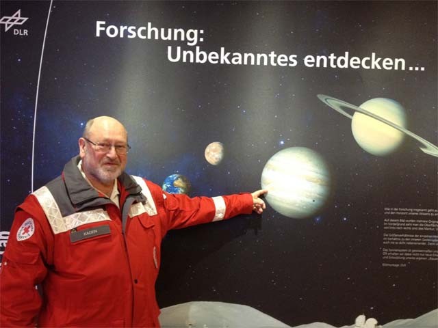 Sanitäter zeigt auf ein Poster des Sonnensystems